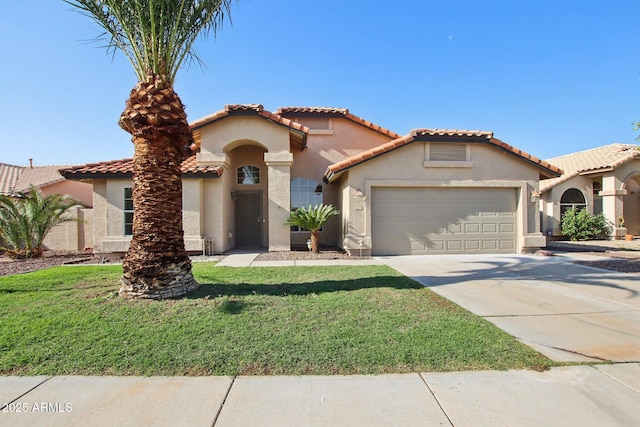 12217 W Edgemont Ave, Avondale, AZ 85392 - mediterranean / spanish home with an attached garage, stucco siding, driveway, and a front yard