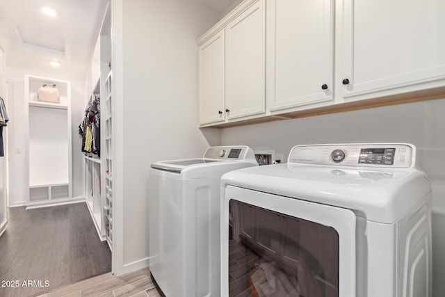 clothes washing area with washer and dryer, recessed lighting, cabinet space, attic access, and light wood-type flooring