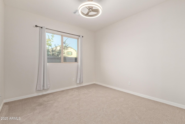 unfurnished room featuring carpet floors, visible vents, and baseboards