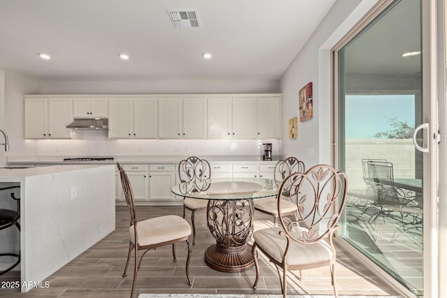 dining area with wood finished floors, visible vents, and recessed lighting