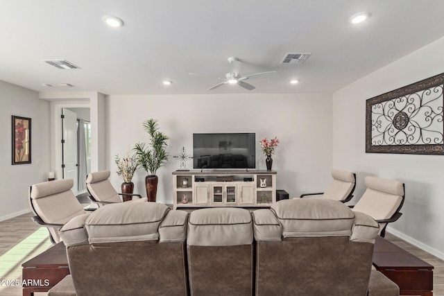 living area featuring recessed lighting, visible vents, and wood finished floors