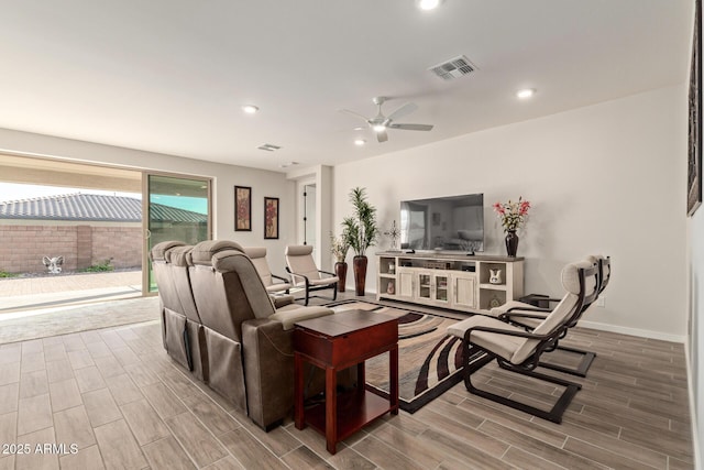 living area with recessed lighting, visible vents, wood tiled floor, ceiling fan, and baseboards