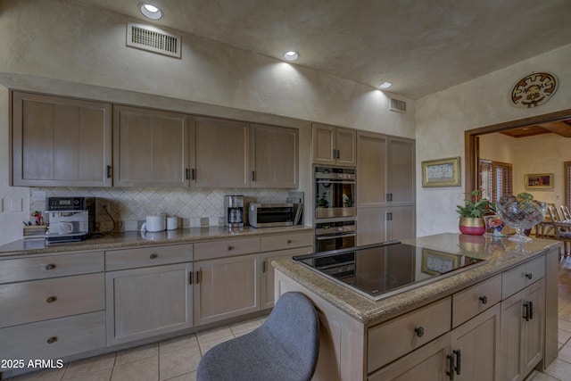 kitchen featuring visible vents, black electric stovetop, double oven, and decorative backsplash