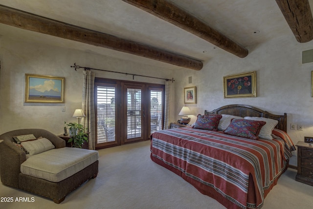 bedroom with beam ceiling, carpet, and access to outside