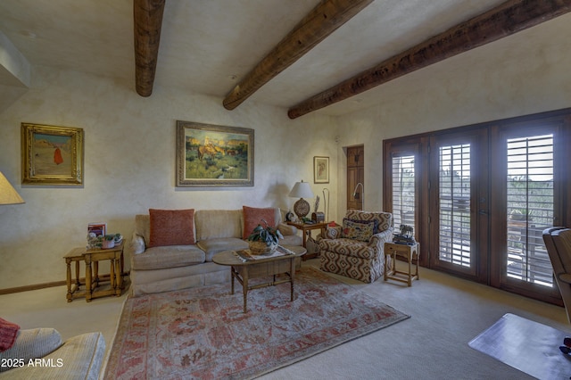 living area featuring beamed ceiling and carpet flooring