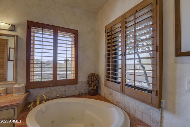 bathroom featuring a tub with jets