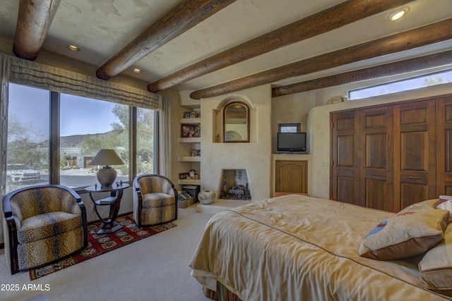 carpeted bedroom featuring beam ceiling and recessed lighting