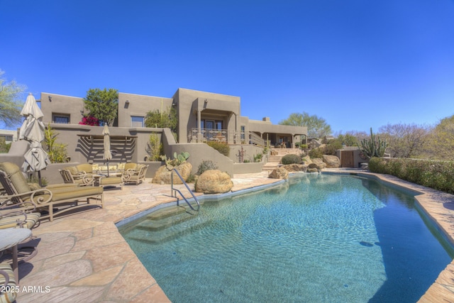 view of pool with stairs, a patio, a fenced in pool, and an outdoor living space