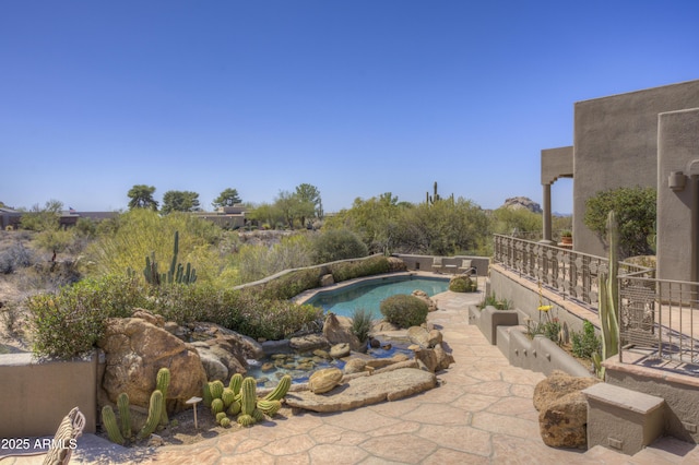 outdoor pool featuring a patio area and fence