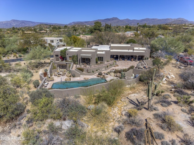 birds eye view of property featuring a mountain view