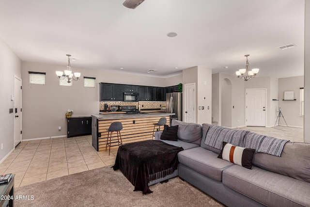 living room with light tile patterned floors, sink, and a chandelier