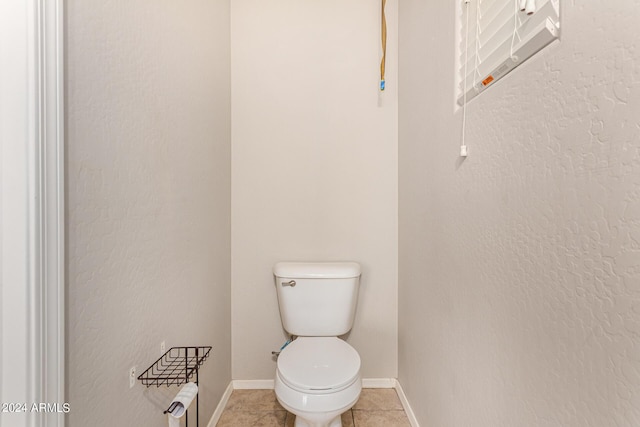 bathroom with tile patterned flooring and toilet