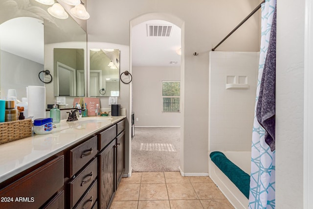 bathroom featuring vanity, shower / bathtub combination with curtain, and tile patterned floors