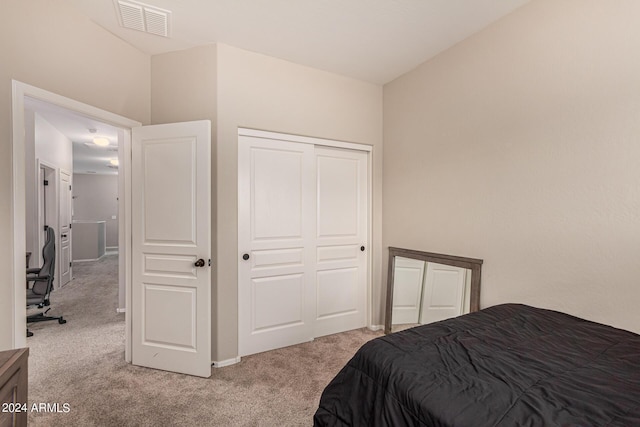 carpeted bedroom featuring a closet