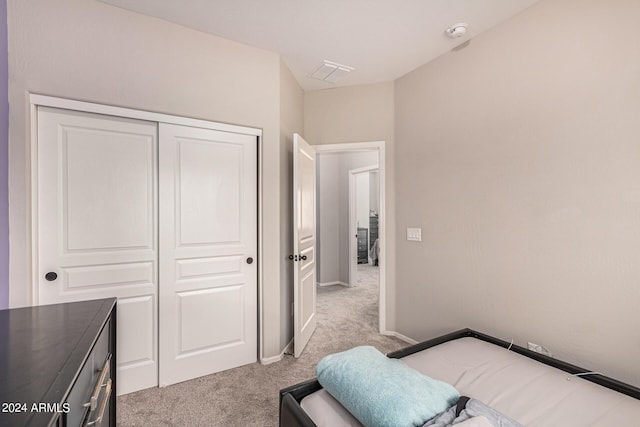 carpeted bedroom featuring a closet