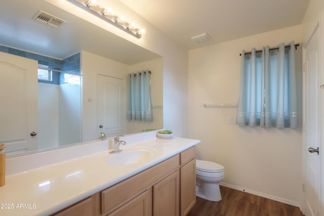 full bath with a shower, visible vents, toilet, vanity, and wood finished floors