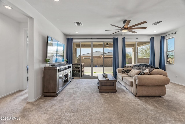 living area with recessed lighting, baseboards, visible vents, and carpet floors