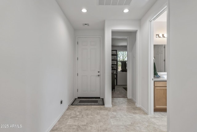 hallway with recessed lighting, visible vents, and baseboards