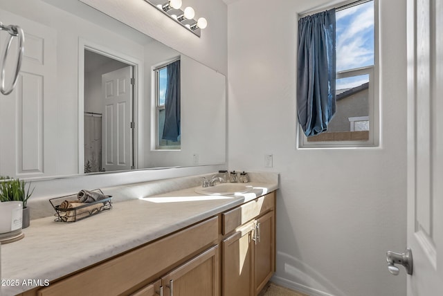 full bathroom featuring baseboards and vanity