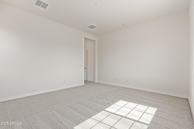 unfurnished room with light carpet, baseboards, and visible vents