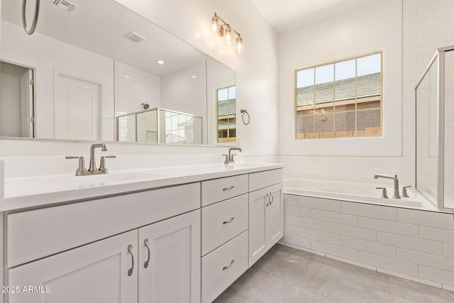 bathroom with double vanity, a sink, visible vents, and a shower stall