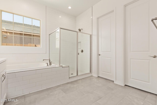 bathroom with vanity, a bath, recessed lighting, and a shower stall