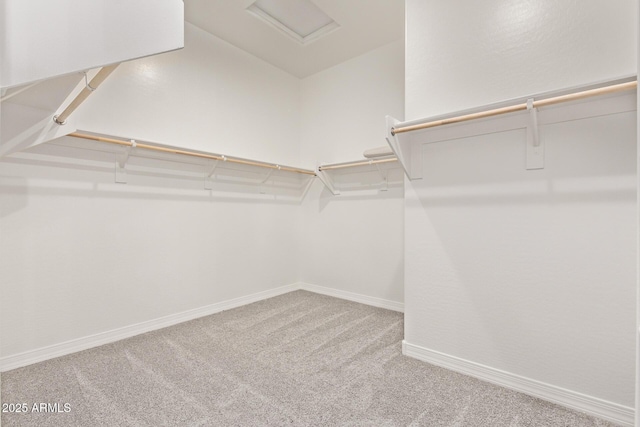 walk in closet with carpet and attic access