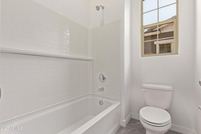 bathroom with baseboards, toilet, shower / tub combination, and tile patterned floors