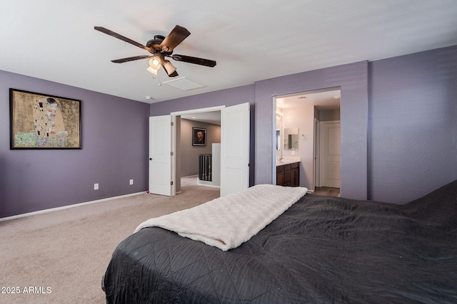 carpeted bedroom with ceiling fan and ensuite bath