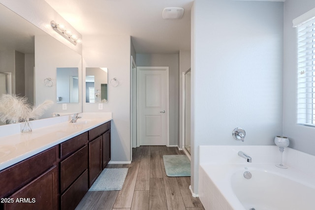 bathroom with independent shower and bath and vanity