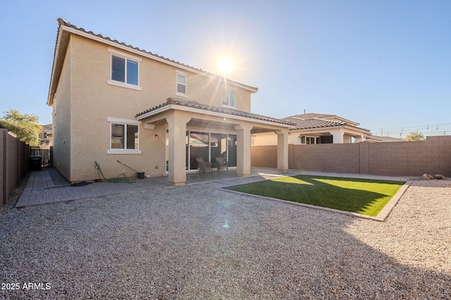 back of house featuring a yard and a patio