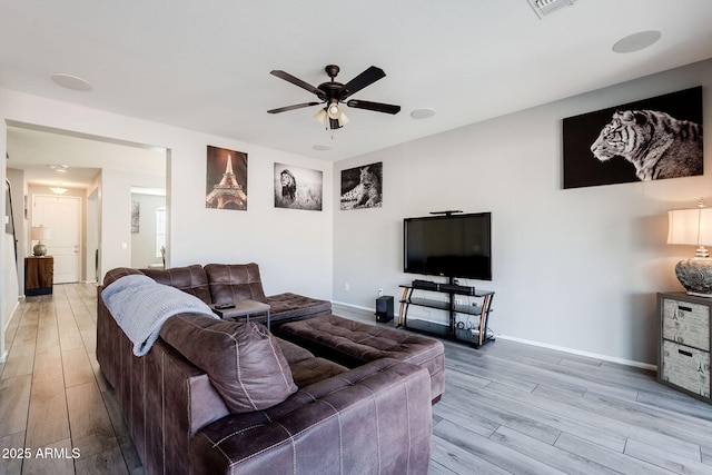 living room featuring ceiling fan and light wood-type flooring