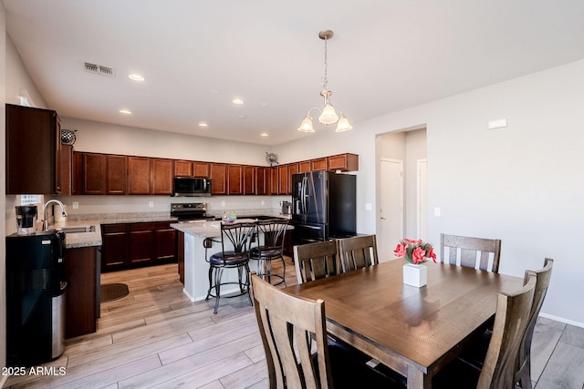 dining room with sink and an inviting chandelier