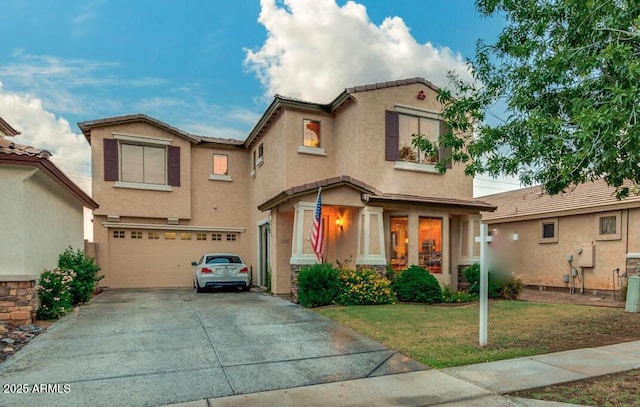 view of front of property featuring a garage and a front lawn