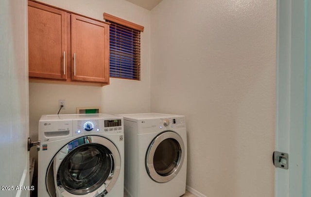 laundry room featuring cabinets and separate washer and dryer