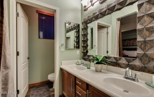 bathroom with vanity, tile patterned flooring, and toilet