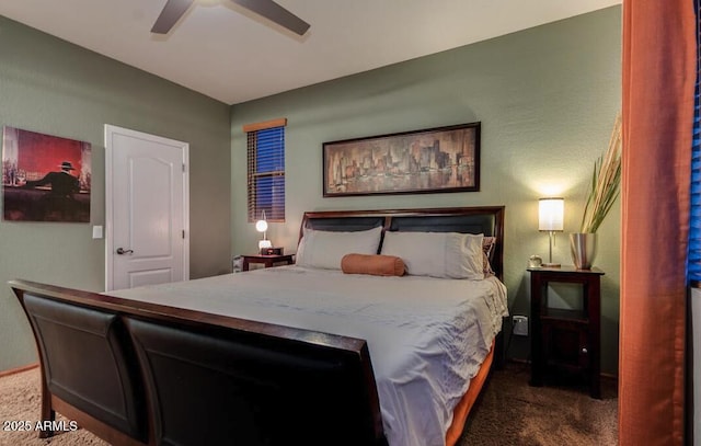 bedroom featuring ceiling fan and dark colored carpet