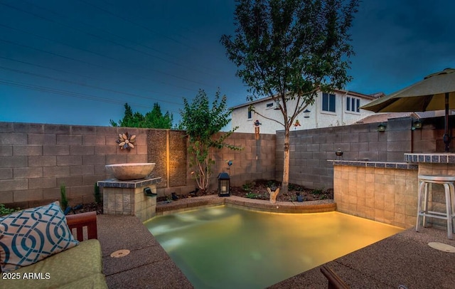 view of pool with an outdoor bar