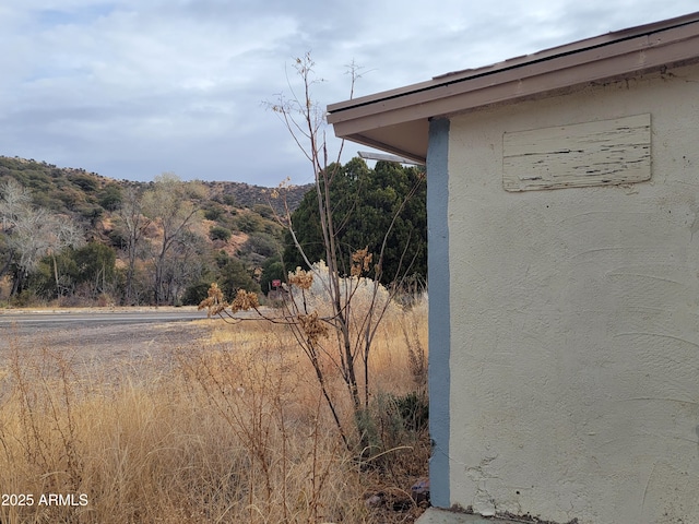 details featuring a mountain view and stucco siding