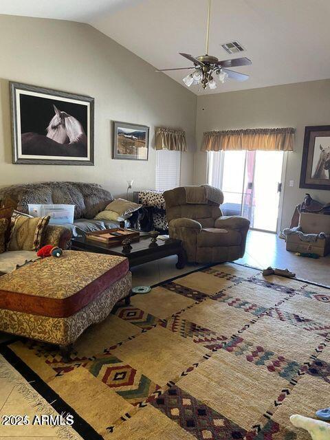 living room with ceiling fan, vaulted ceiling, and visible vents