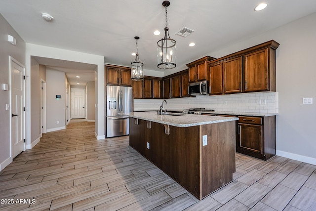 10036 E Naranja Ave, Mesa, AZ 85209 - kitchen with appliances with stainless steel finishes, decorative backsplash, light wood finished floors, and recessed lighting