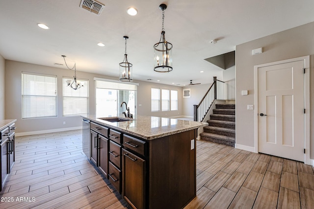 10036 E Naranja Ave, Mesa, AZ 85209 - kitchen with a chandelier, wood finish floors, dark brown cabinets, hanging light fixtures, and recessed lighting