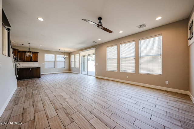 10036 E Naranja Ave, Mesa, AZ 85209 - unfurnished living room with a chandelier, ceiling fan, recessed lighting, and light wood-style floors