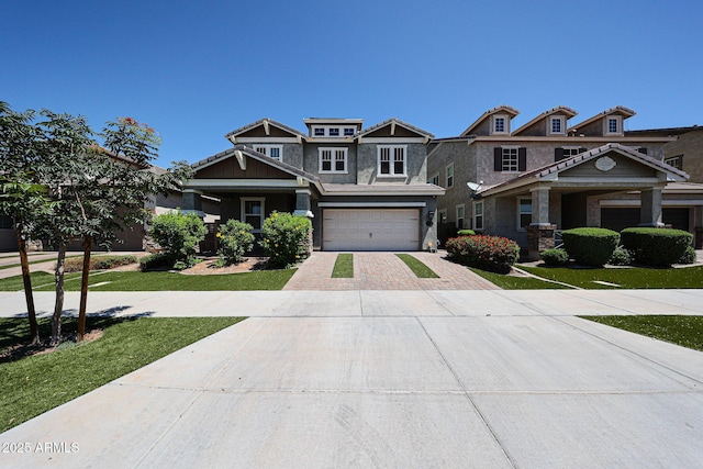 10036 E Naranja Ave, Mesa, AZ 85209 - craftsman-style house with decorative driveway, stone siding, a front lawn, and an attached garage