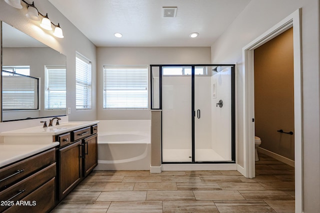 10036 E Naranja Ave, Mesa, AZ 85209 - full bathroom featuring a bath, a shower stall, vanity, wood tiled floors, and recessed lighting