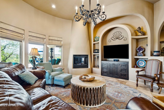 living area with built in shelves, a fireplace, and a high ceiling