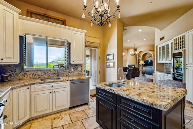 kitchen featuring a sink, stainless steel dishwasher, cream cabinets, backsplash, and recessed lighting