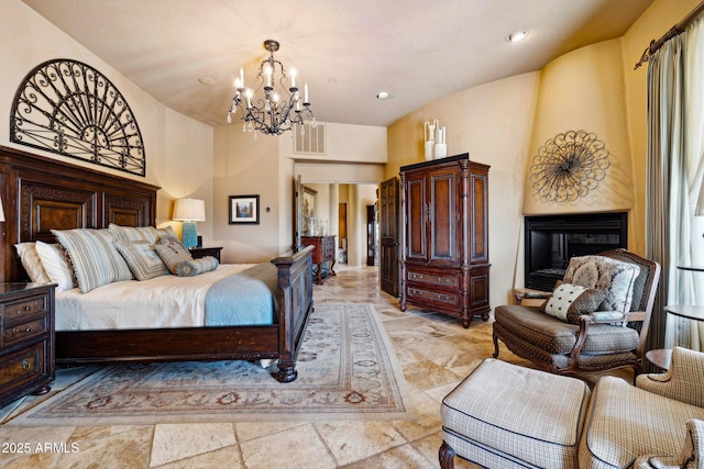 bedroom featuring a fireplace, a chandelier, and recessed lighting
