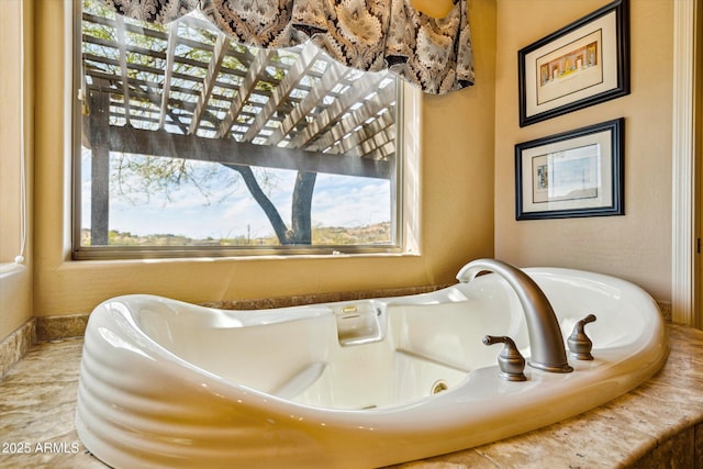 bathroom featuring a tub with jets