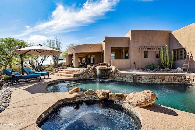 swimming pool with an in-ground hot tub and a patio area